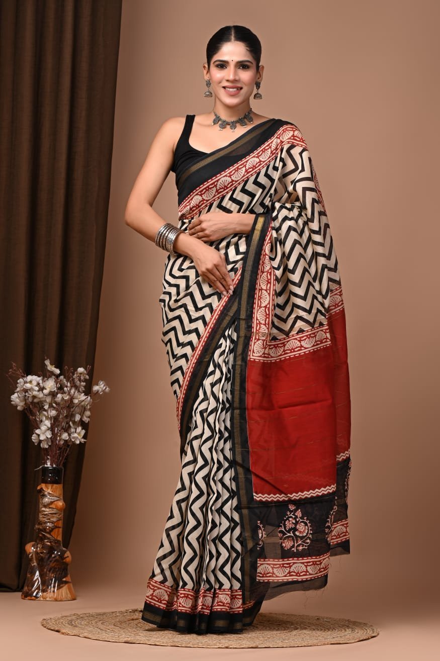 Woman wearing cream Chanderi silk saree with black chevron print and red Bagru block print border