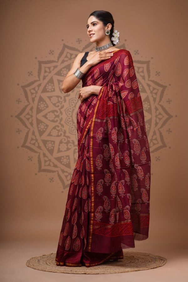 Woman wearing maroon Chanderi silk saree with Bagru hand block printed paisley motifs and scroll border