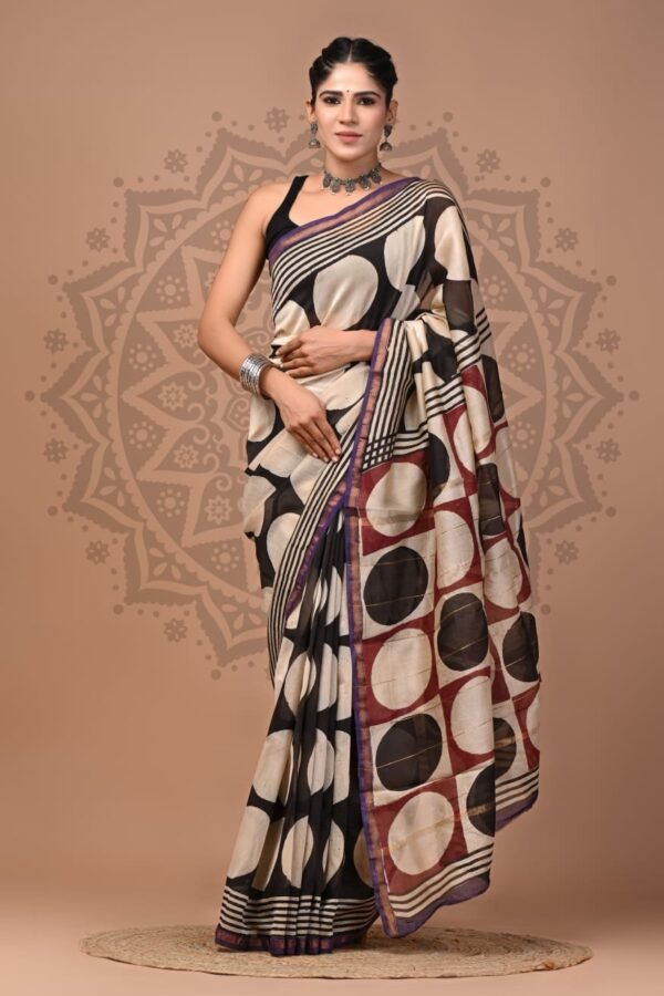 Woman draped in black and cream Chanderi silk saree with hand block printed circle motif and maroon pallu