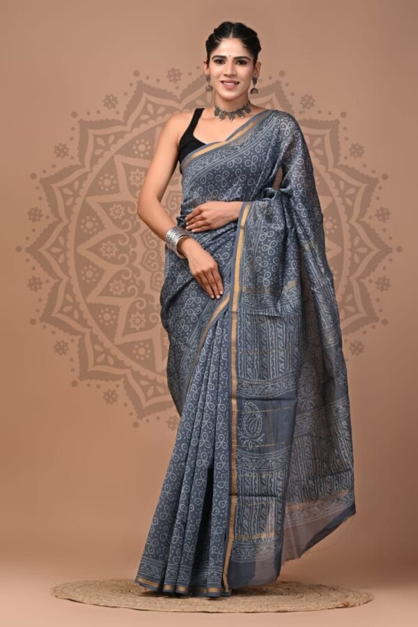 Woman wearing grey Chanderi silk saree with Bagru hand block printed paisley motif and gold border