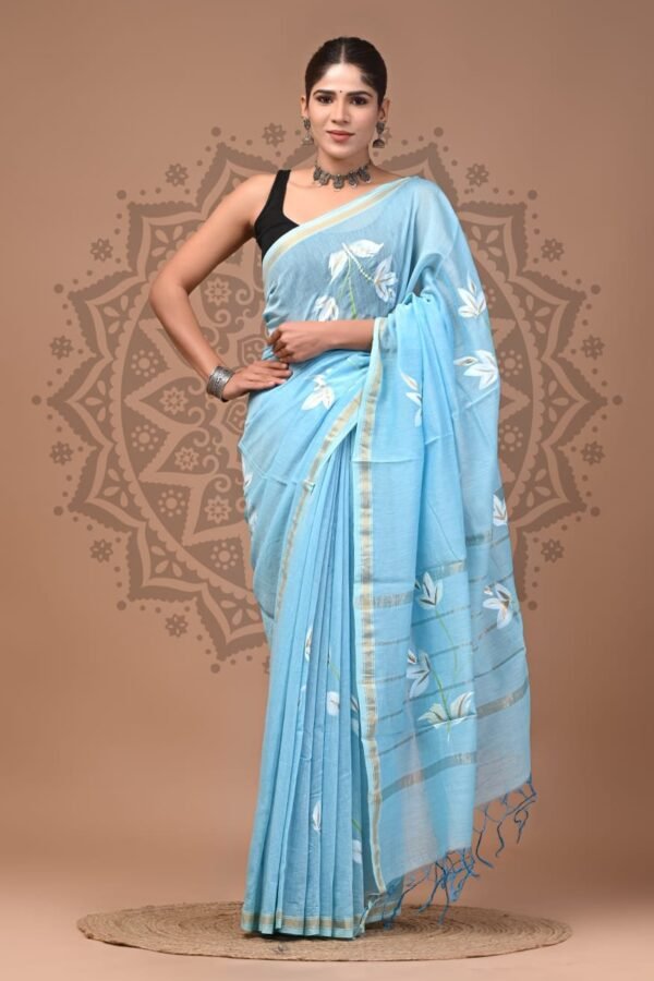 Sky blue Chanderi silk saree with Bagru hand block printed white lily floral motifs and gold border