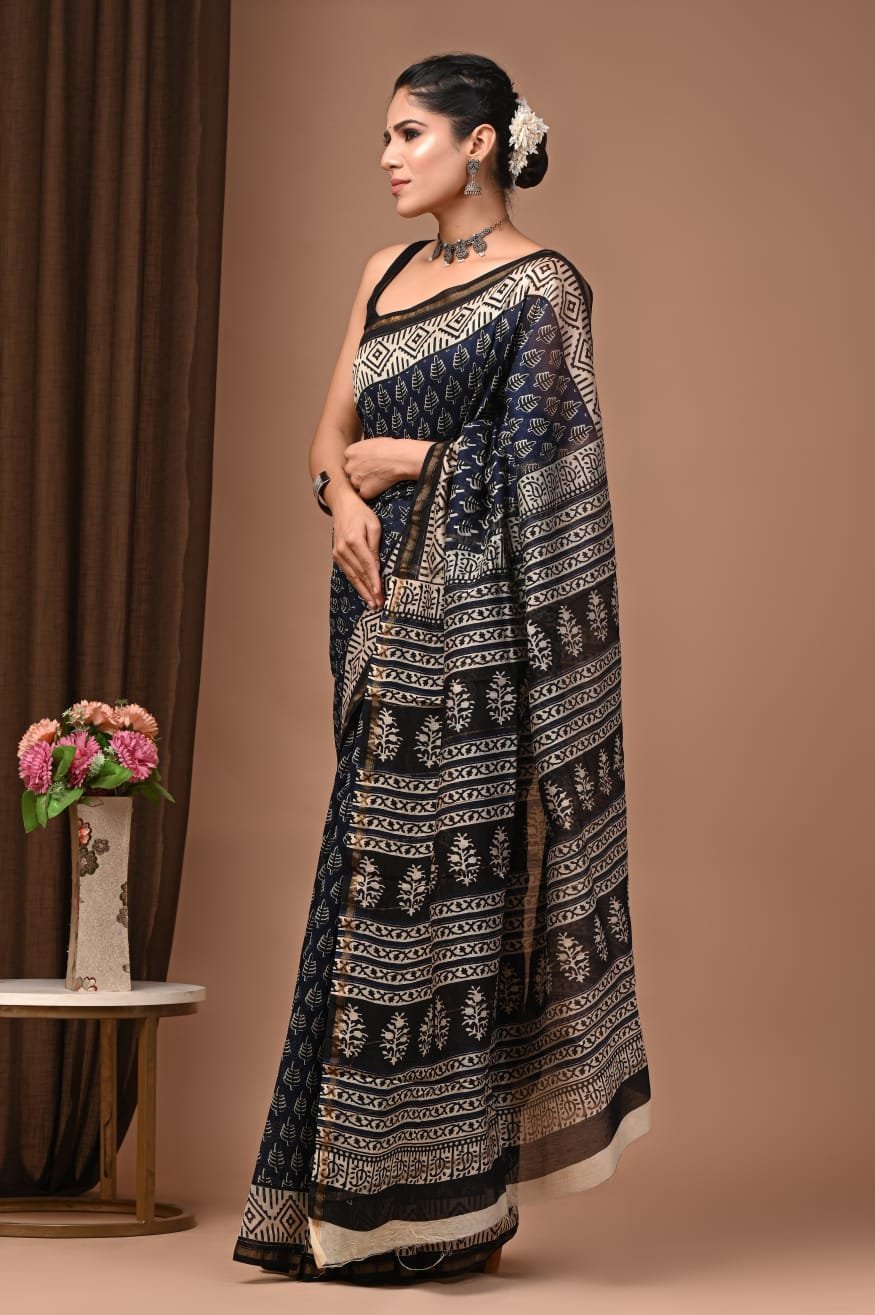 Woman wearing navy black Chanderi silk saree with Bagru hand block printed leaf and diamond border