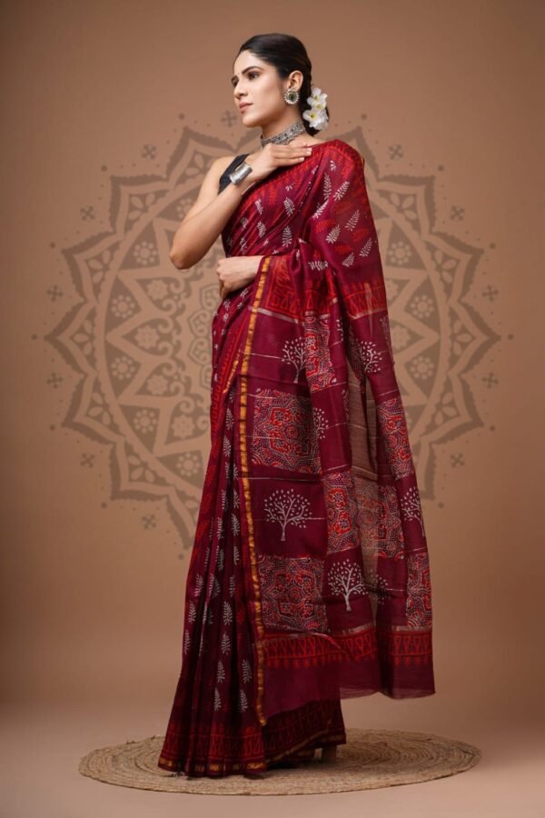 Woman draped in maroon Chanderi silk saree with Bagru hand block printed fern and tree motifs