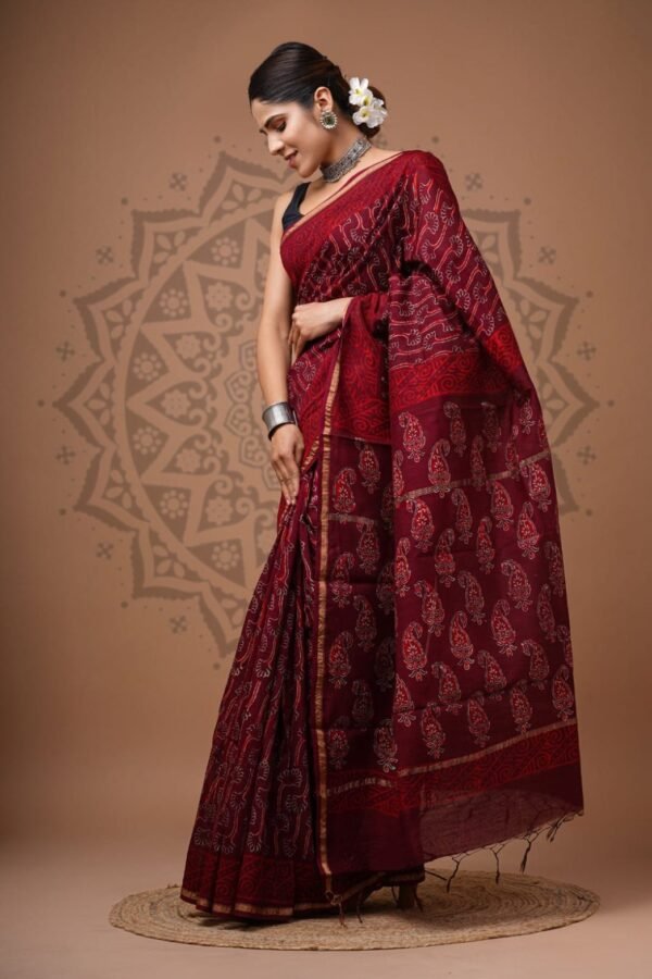 Woman draped in maroon Chanderi silk saree with Bagru hand block printed paisley pallu