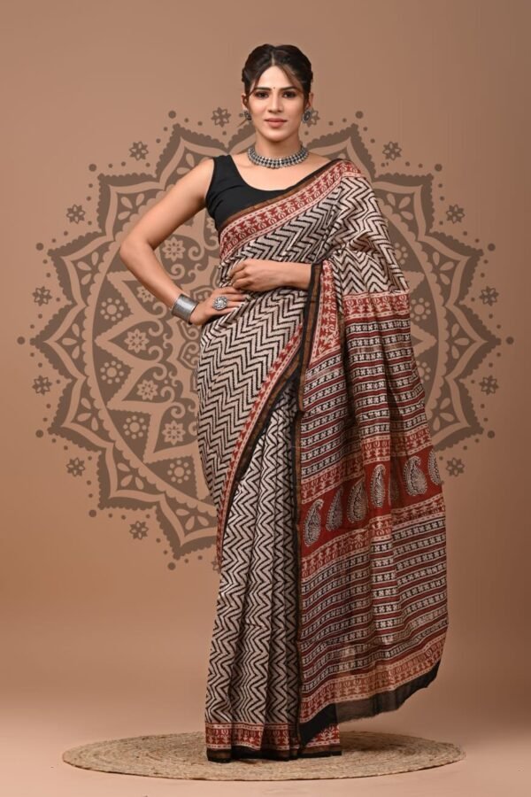 Woman wearing black and cream chevron Chanderi silk saree with rust paisley border, Bagru hand block print