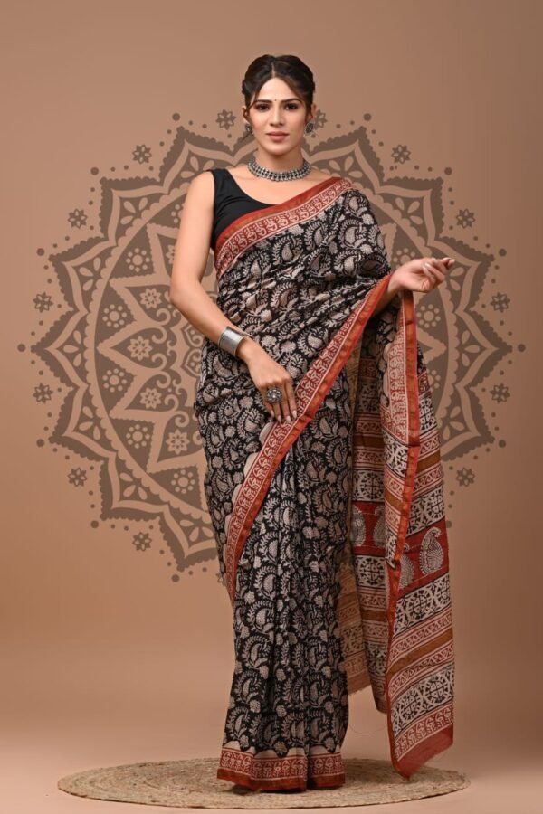 Woman wearing black Chanderi silk saree with off-white floral block print and rust paisley border