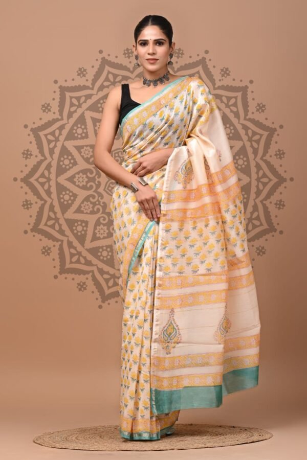 Woman draped in cream Chanderi silk saree with yellow floral print and sea-green border