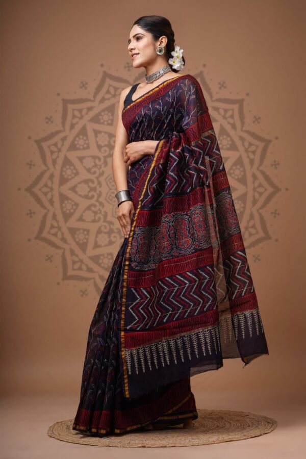 Woman draped in navy Chanderi silk saree with red zigzag chevron print and leaf-motif border