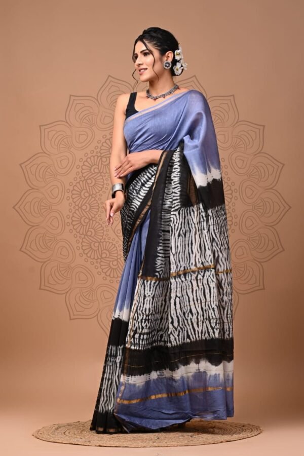 Woman draped in periwinkle blue Chanderi silk saree with black-white zigzag print pallu and black border