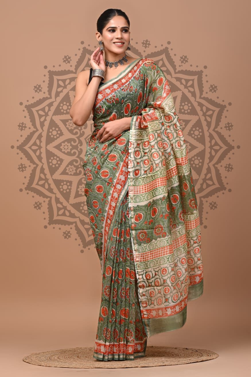 Woman wearing sage green Chanderi silk saree with rust medallion print and checkered border
