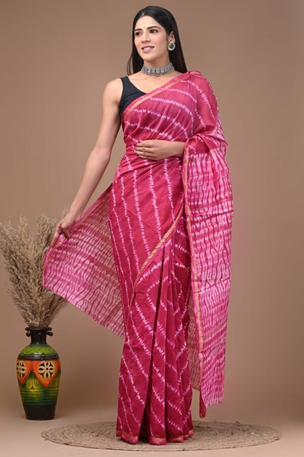 Woman in magenta pink Chanderi silk saree with diagonal wave stripe Bagru block print and gold border