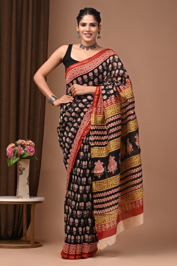 Woman wearing black Chanderi silk saree with pink floral print, red border, Bagru hand block print