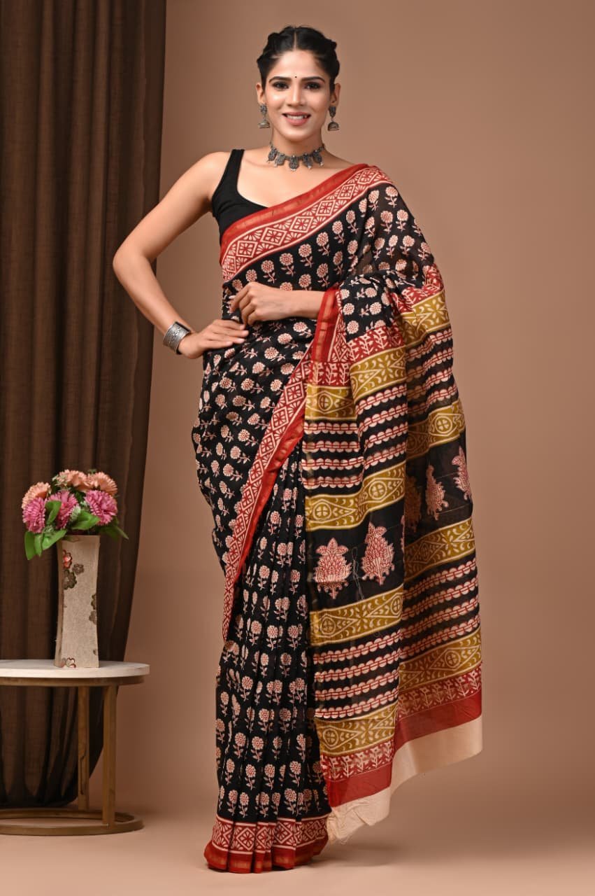 Woman wearing black Chanderi silk saree with pink floral print, red border, Bagru hand block print