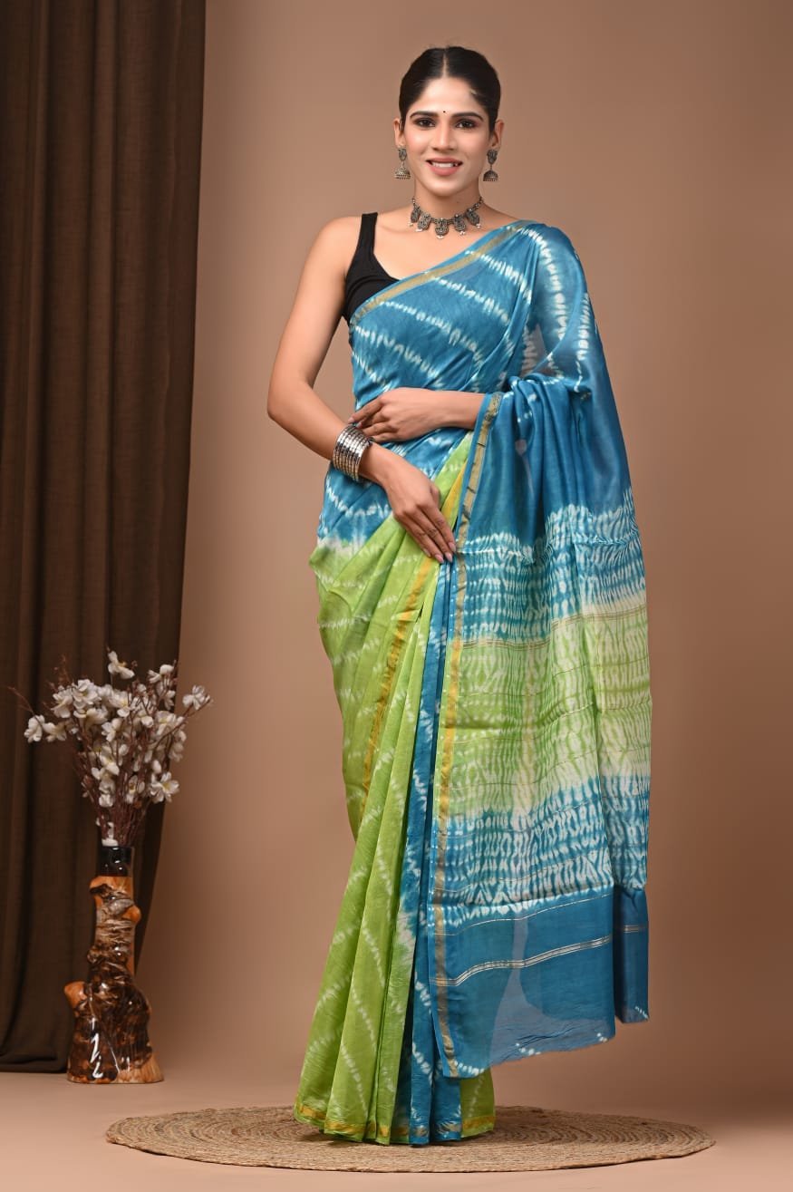 Woman draped in blue and green Chanderi silk saree with Bagru hand block wave print