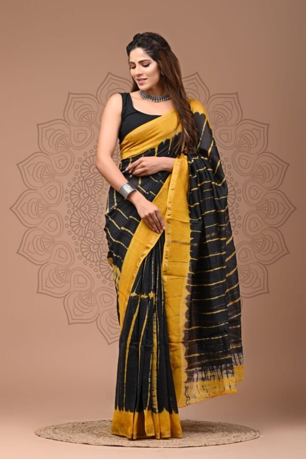 Woman draped in black and yellow Chanderi silk saree with Bagru hand block wave print and yellow border