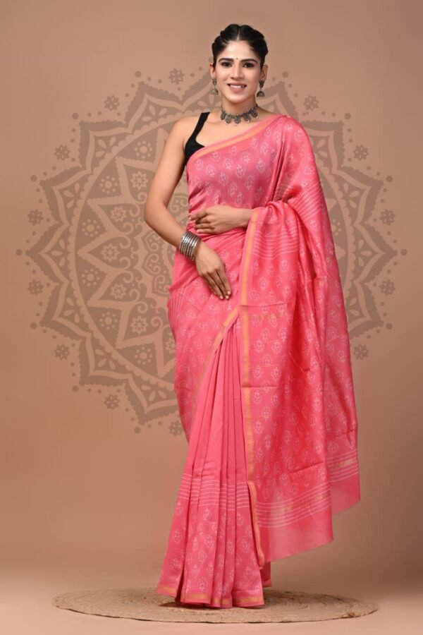 Woman draped in pink Chanderi silk saree with white floral booti hand block print and gold border