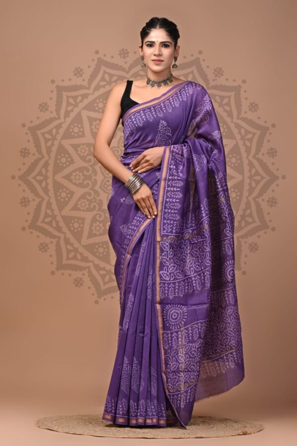 Woman draped in purple Chanderi silk saree with white floral hand block print and gold border