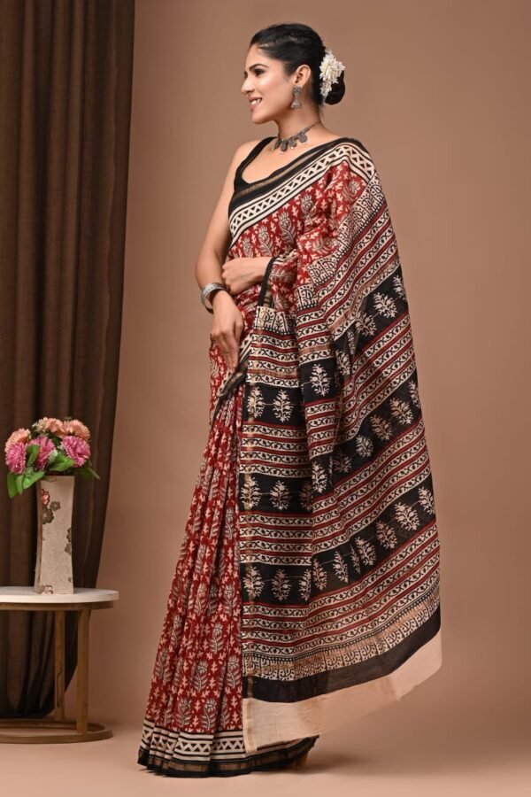 Woman draped in maroon and black Chanderi silk saree with Bagru hand block floral print and striped pallu border