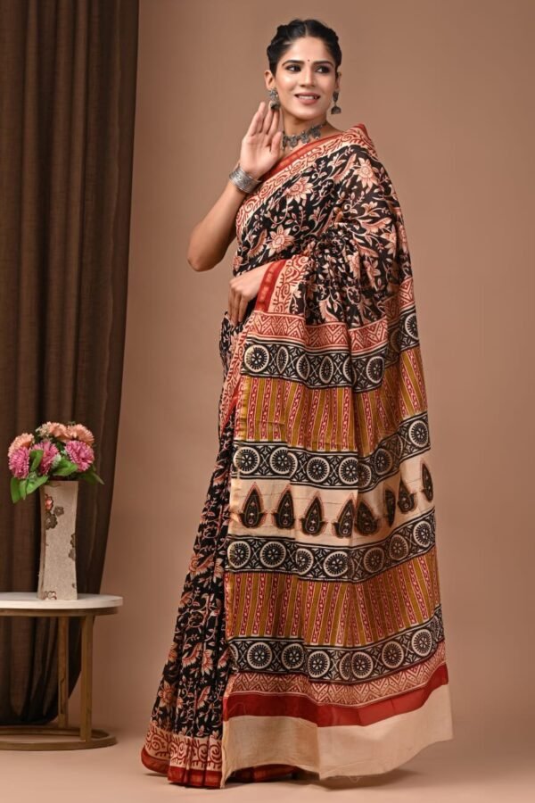 Woman draped in black Chanderi silk saree with Bagru hand block floral and medallion print border