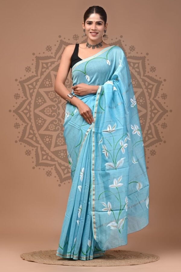 Woman draped in sky blue Chanderi silk saree with white floral hand block print and gold border