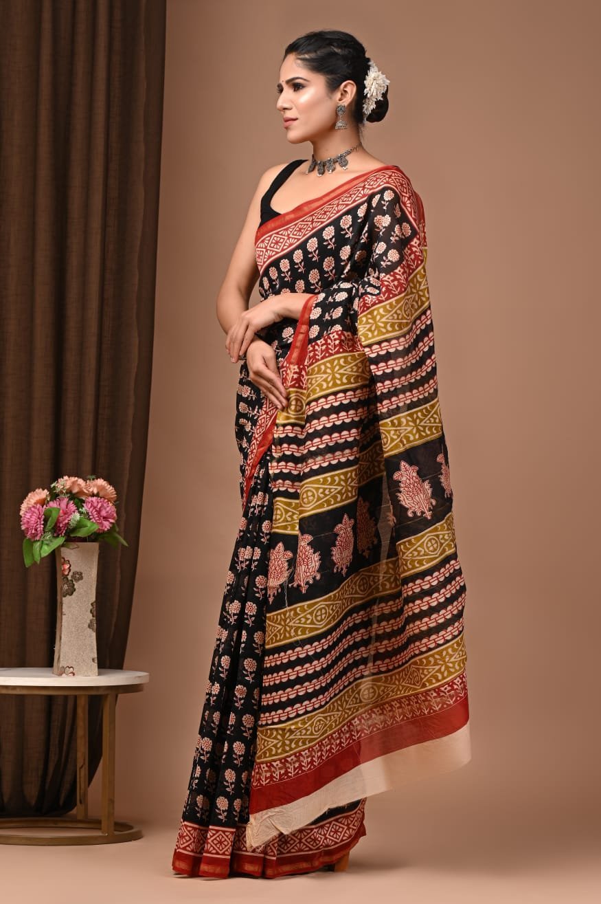 Woman draped in black Chanderi silk saree with Bagru hand block floral print and mustard-red pallu border