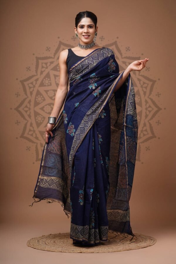 Woman draped in navy blue Chanderi silk saree with hand block floral and geometric print border