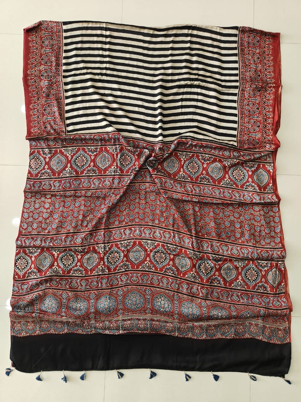 Ajrakh print pure modal silk saree with black white stripes and rust-red floral border with tassels