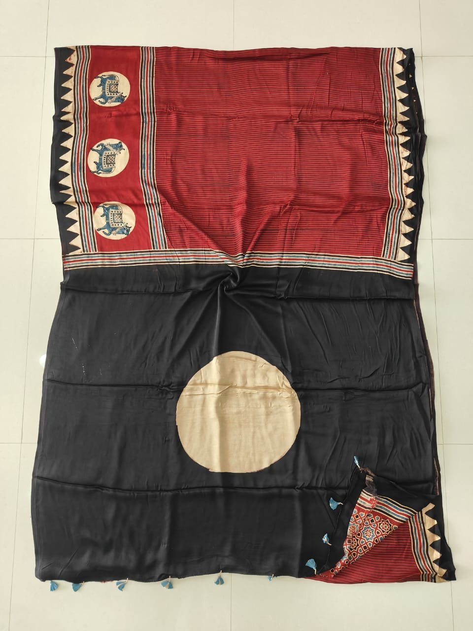 Black Ajrakh print modal silk saree with cream circle motifs and rust-red elephant motif border
