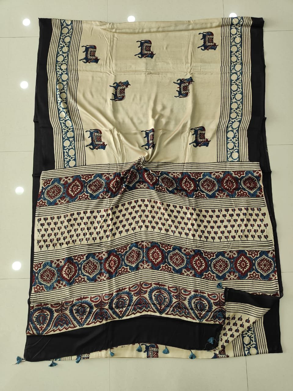 Cream Ajrakh print modal silk saree with elephant motifs and floral medallion pallu