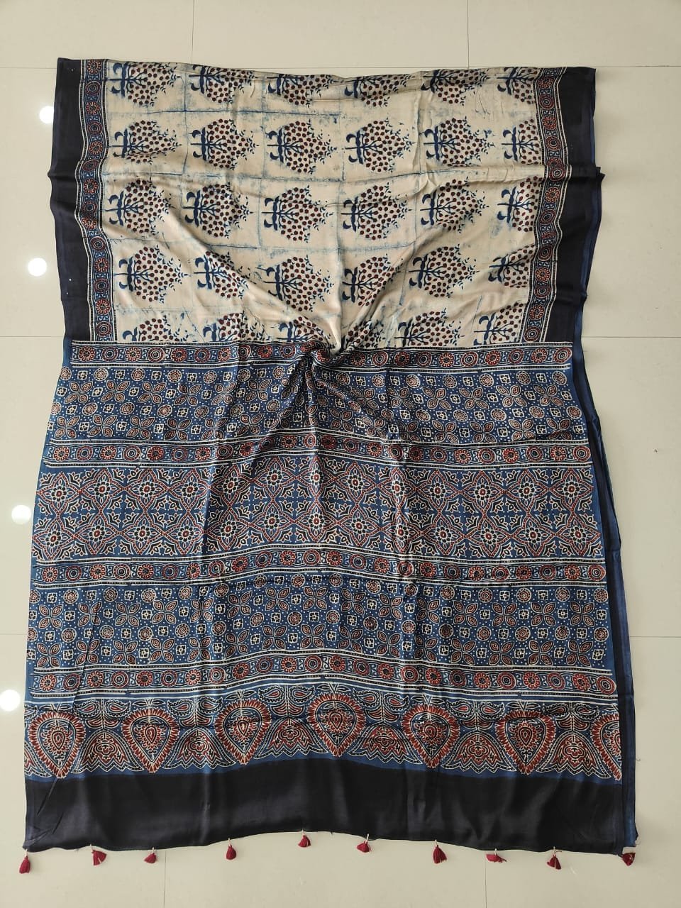 Cream Ajrakh print modal silk saree with botanical booti motifs and indigo floral border