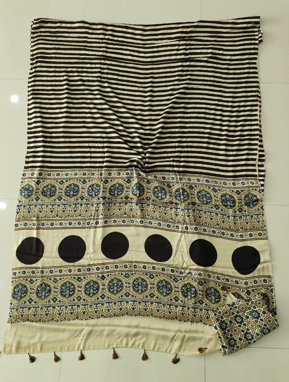 Black and cream striped Ajrakh print Modal silk saree with circular medallion border, laid flat