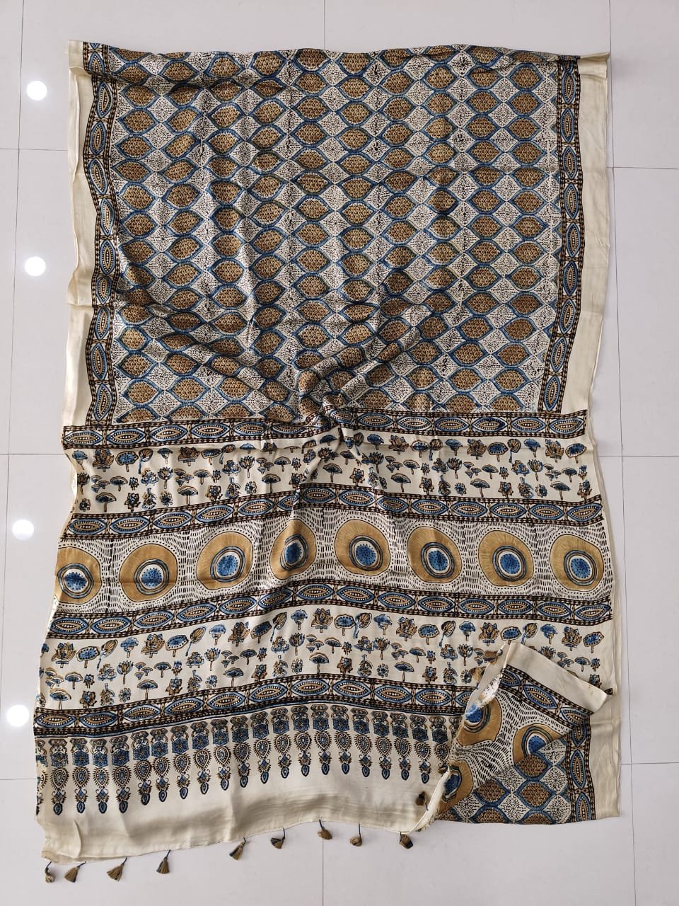 Cream Ajrakh print modal silk saree with oval lattice body and sunburst medallion pallu