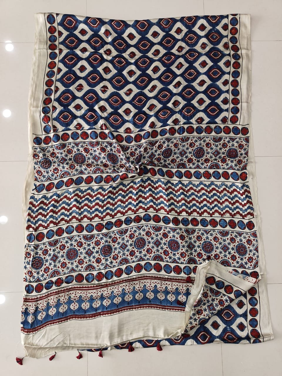 Navy and cream Ajrakh print modal silk saree with diamond lattice body and floral medallion pallu