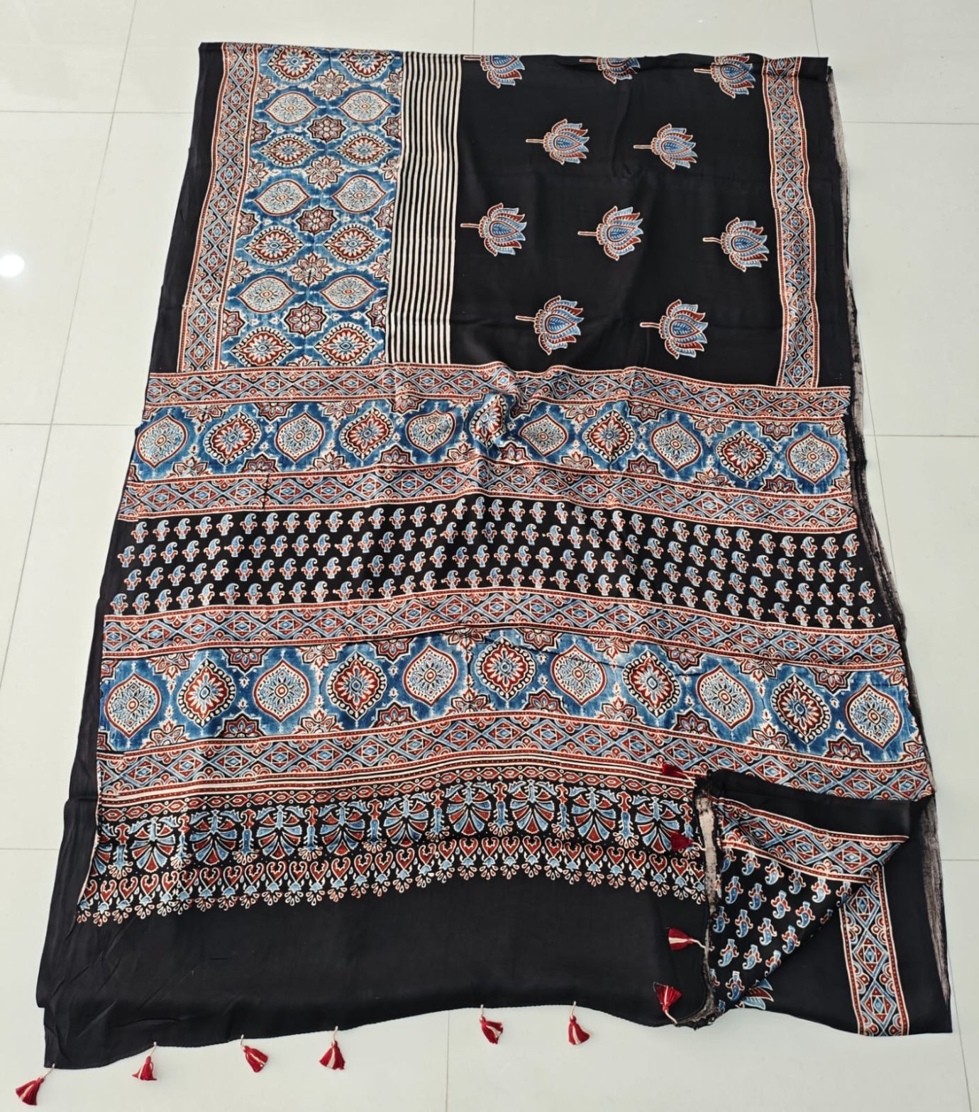 Black Ajrakh print pure modal silk saree with blue-red geometric border and floral booti