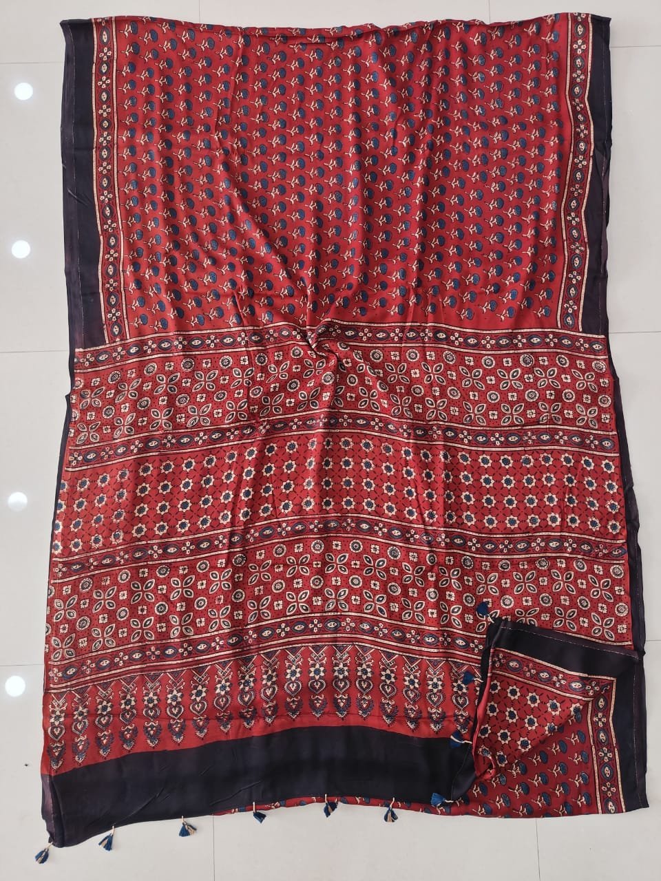 Rust red Ajrakh print pure Modal Silk saree with navy border and floral pallu