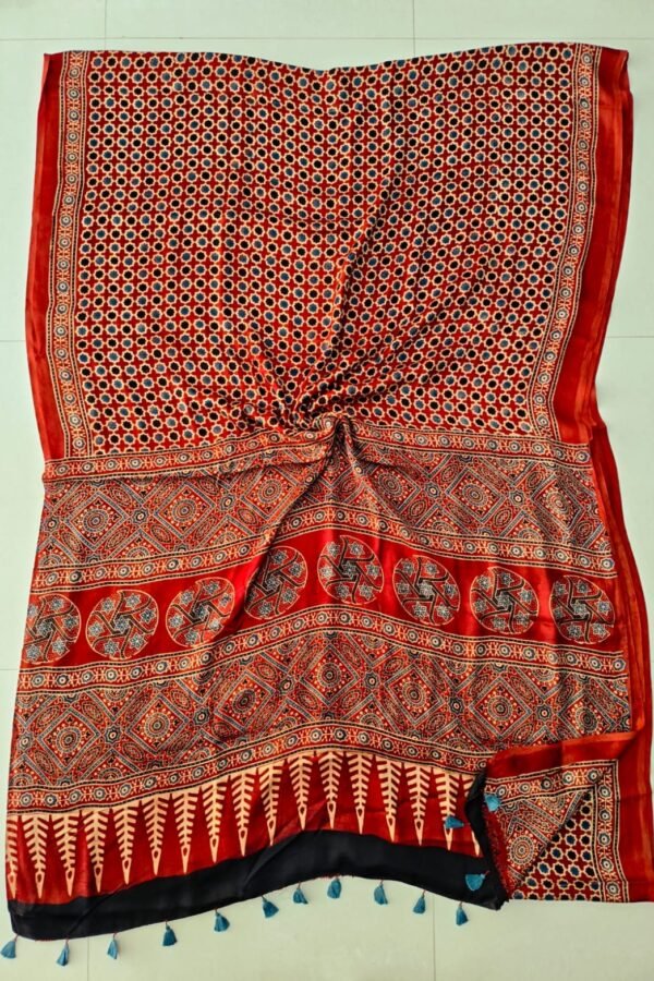 Red Ajrakh print pure Modal silk saree with geometric booti and black border with blue tassels