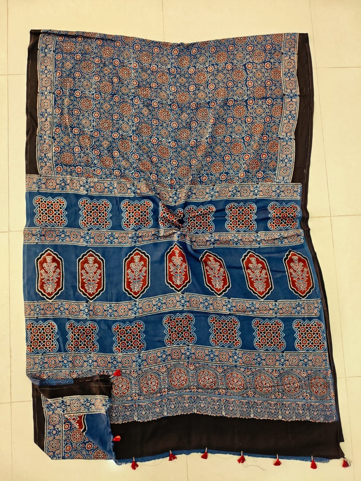 Steel blue Ajrakh print pure Modal silk saree with rust-red medallion pallu and black border