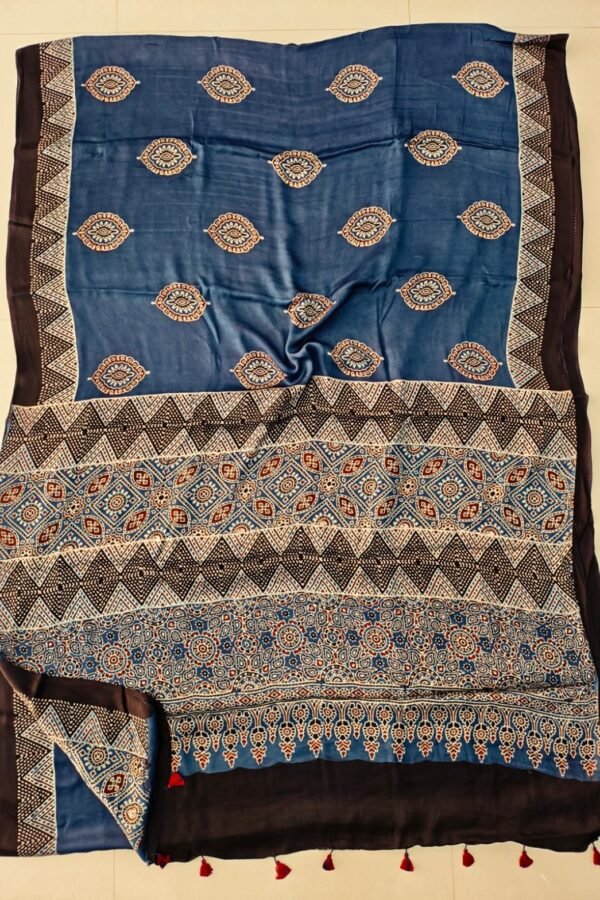 Denim blue Ajrakh print silk saree with paisley booti and chevron pallu, black border with red tassels