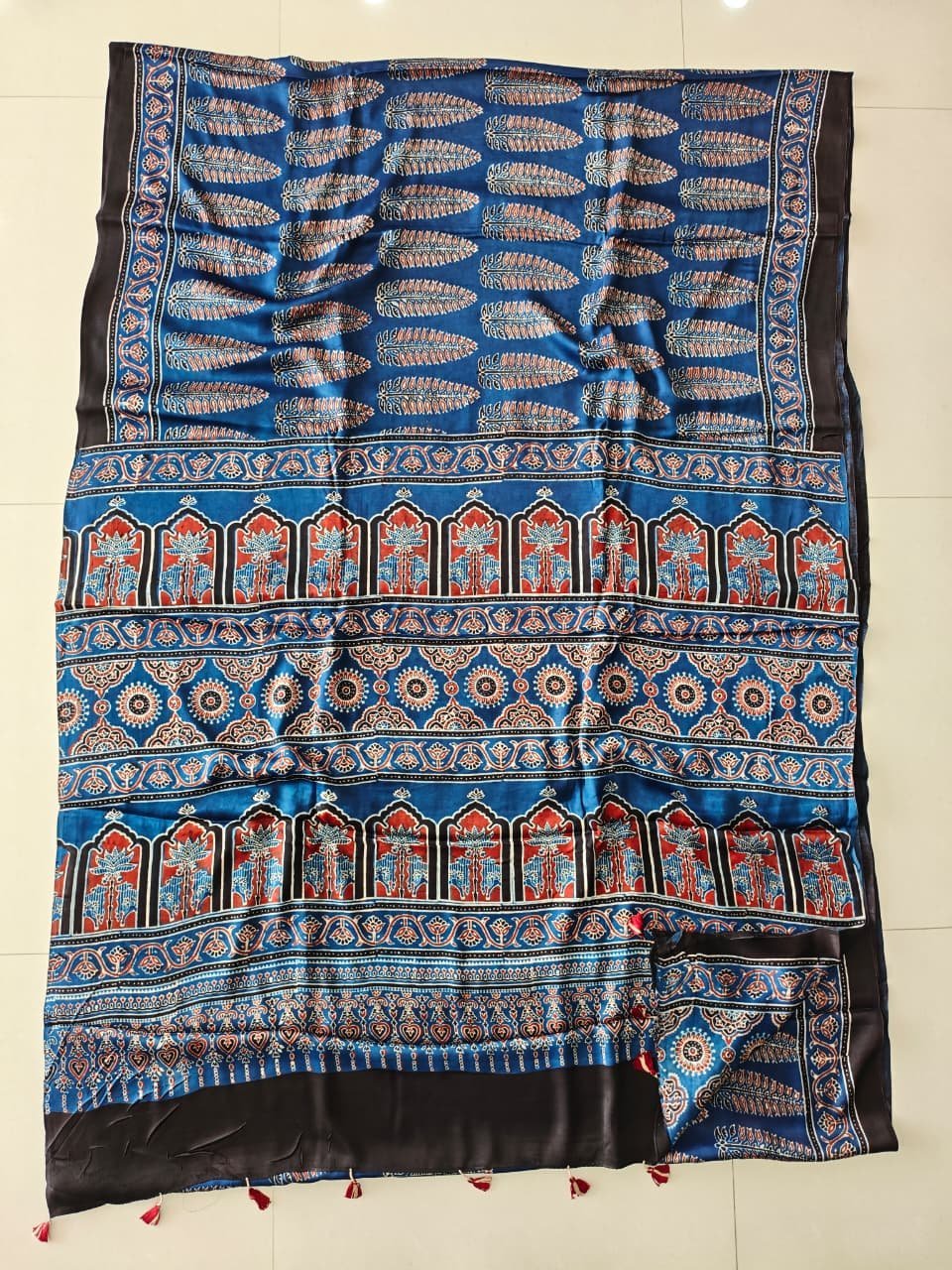 Blue Ajrakh print Modal silk saree with temple medallion pallu and black tasseled border