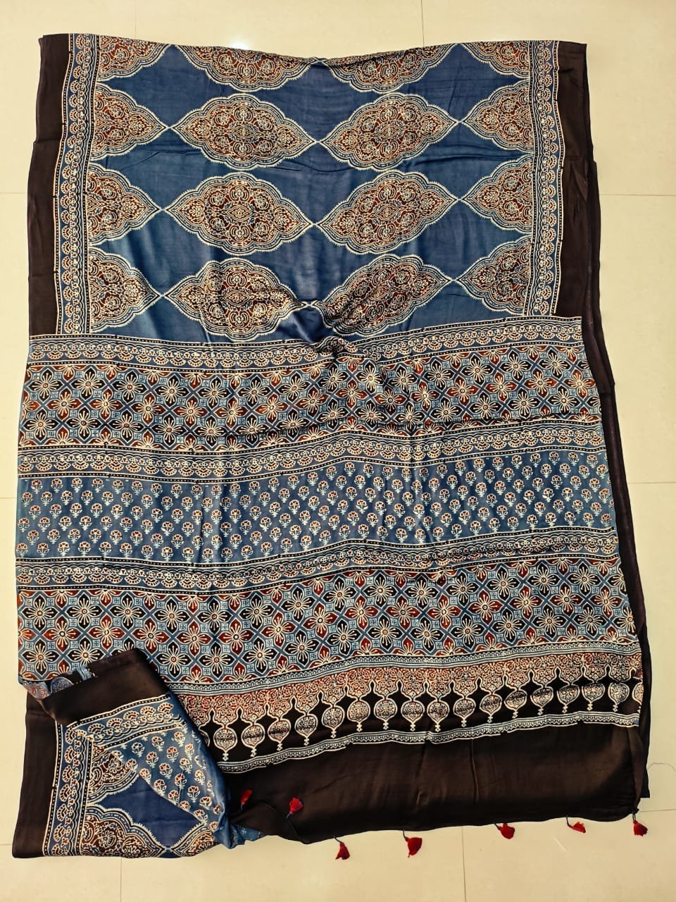 Steel blue Ajrakh print Modal silk saree with ogee lattice medallions and black border