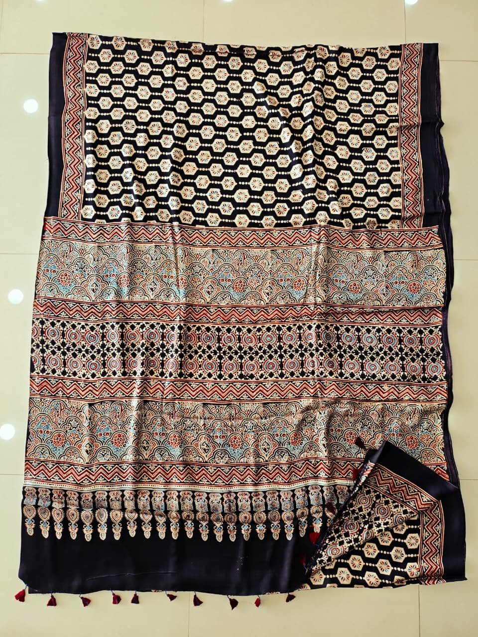 Black Ajrakh print pure Modal silk saree with honeycomb booti and scalloped pallu border