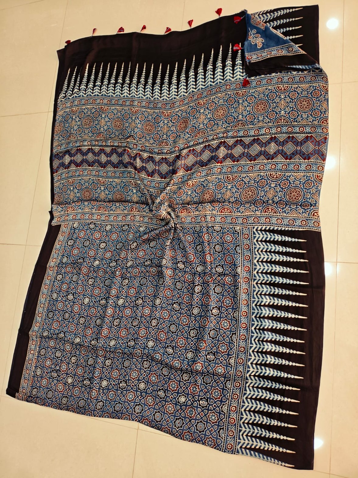 Steel blue Ajrakh print silk saree with star-flower lattice body and black leaf-motif border