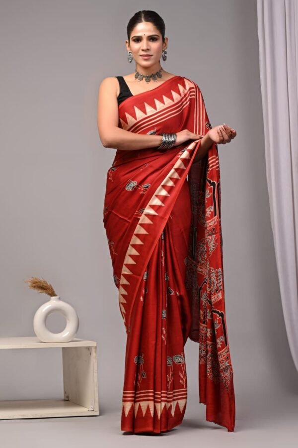 Woman draped in red Ajrakh print Modal silk saree with zigzag border and floral pallu