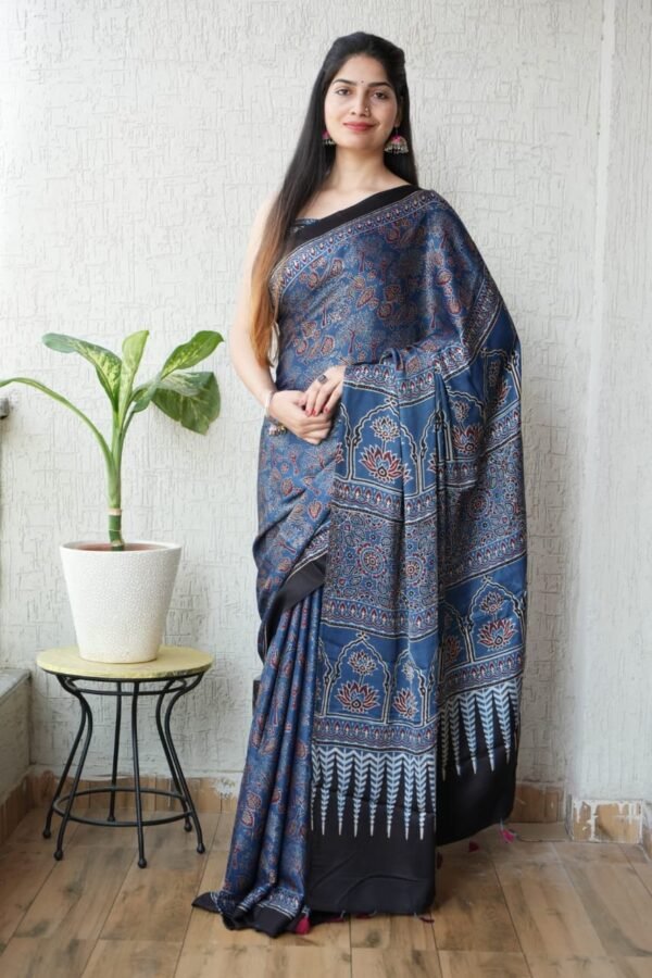Woman draped in indigo blue Ajrakh print Modal Silk saree with temple arch pallu and black border