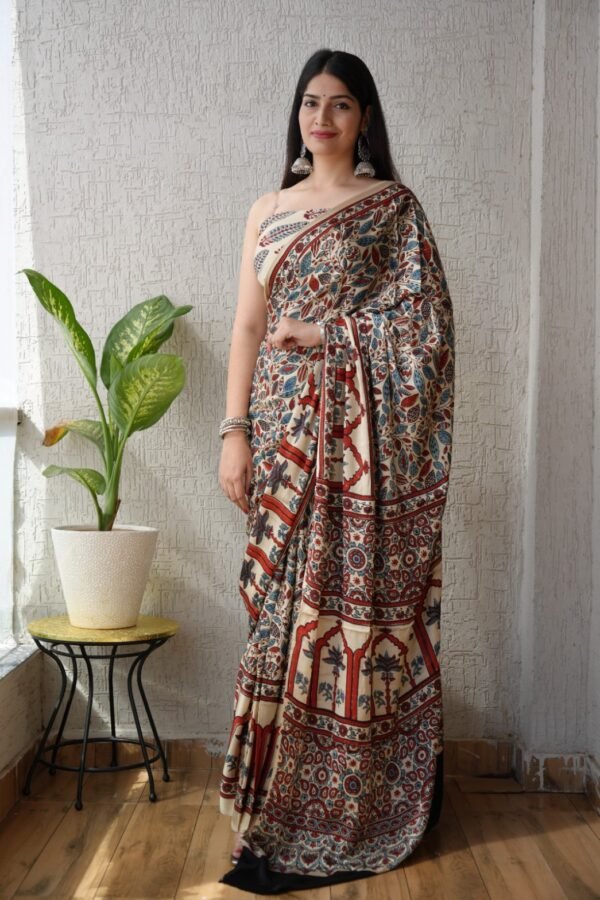 Woman in ivory Ajrakh print Modal silk saree with floral vine pattern and temple arch border