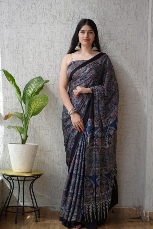 Woman wearing indigo blue Ajrakh print Modal Silk saree with black floral border