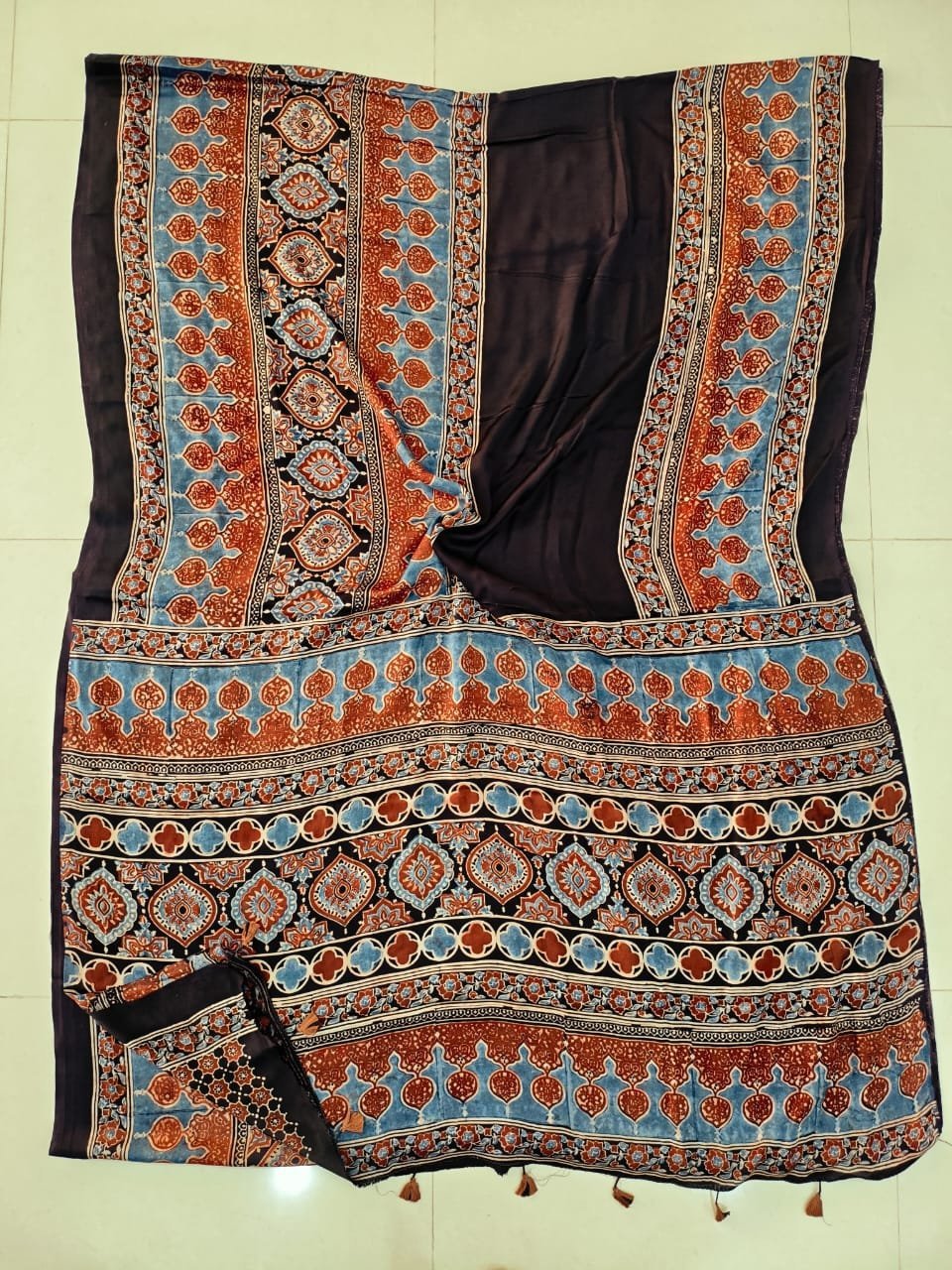 Brown Ajrakh print Modal silk saree with rust-red and blue paisley medallion border and pallu