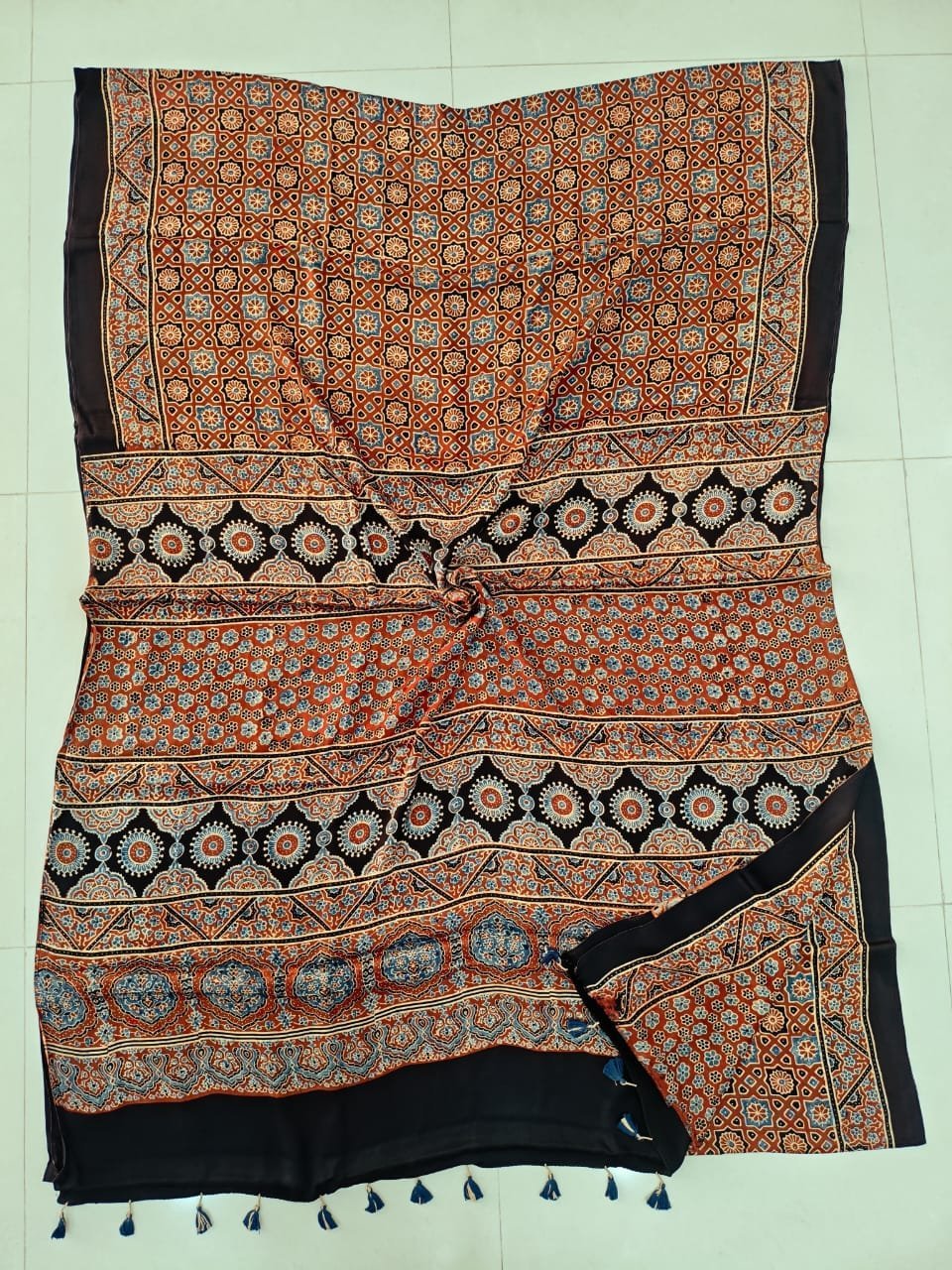 Rust orange Ajrakh print pure Modal silk saree with black border and blue tassels