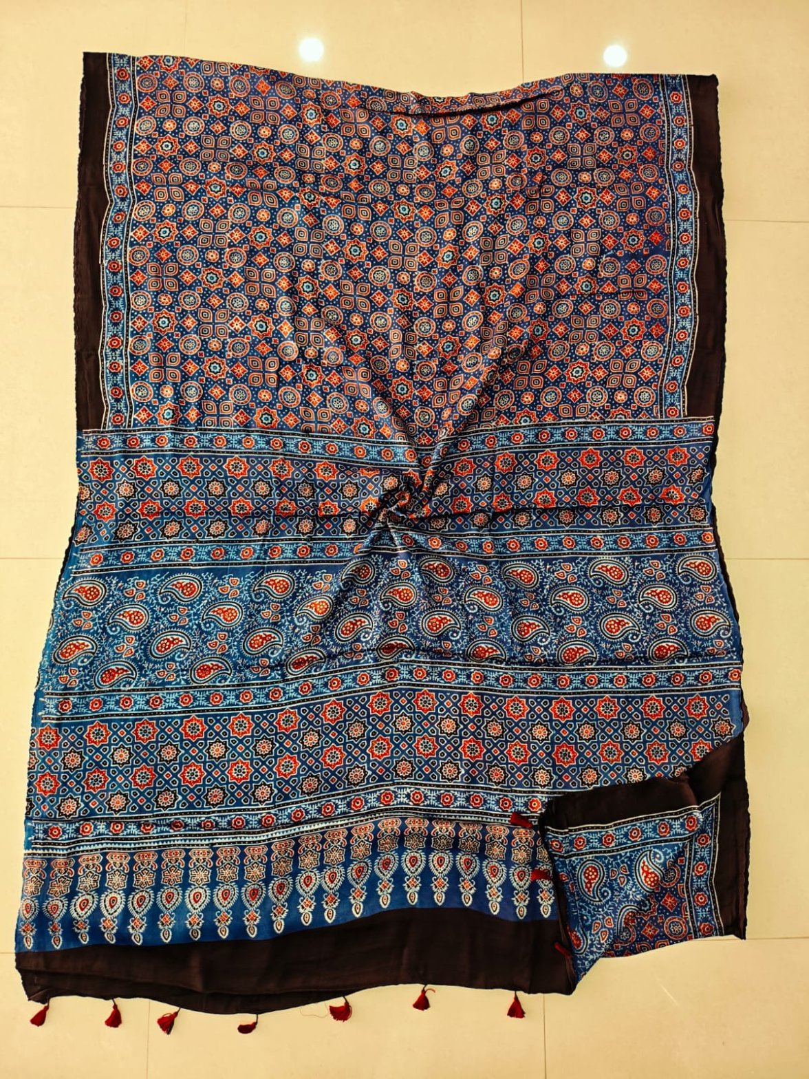Indigo blue Ajrakh print pure Modal silk saree with paisley border and maroon tassels