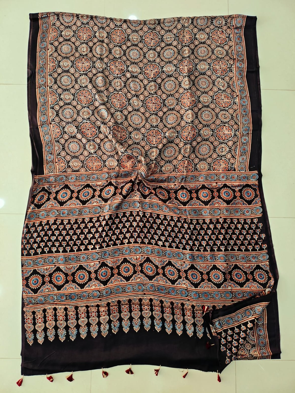 Dark brown Ajrakh print pure Modal Silk saree with circular floral medallions and maroon tassels